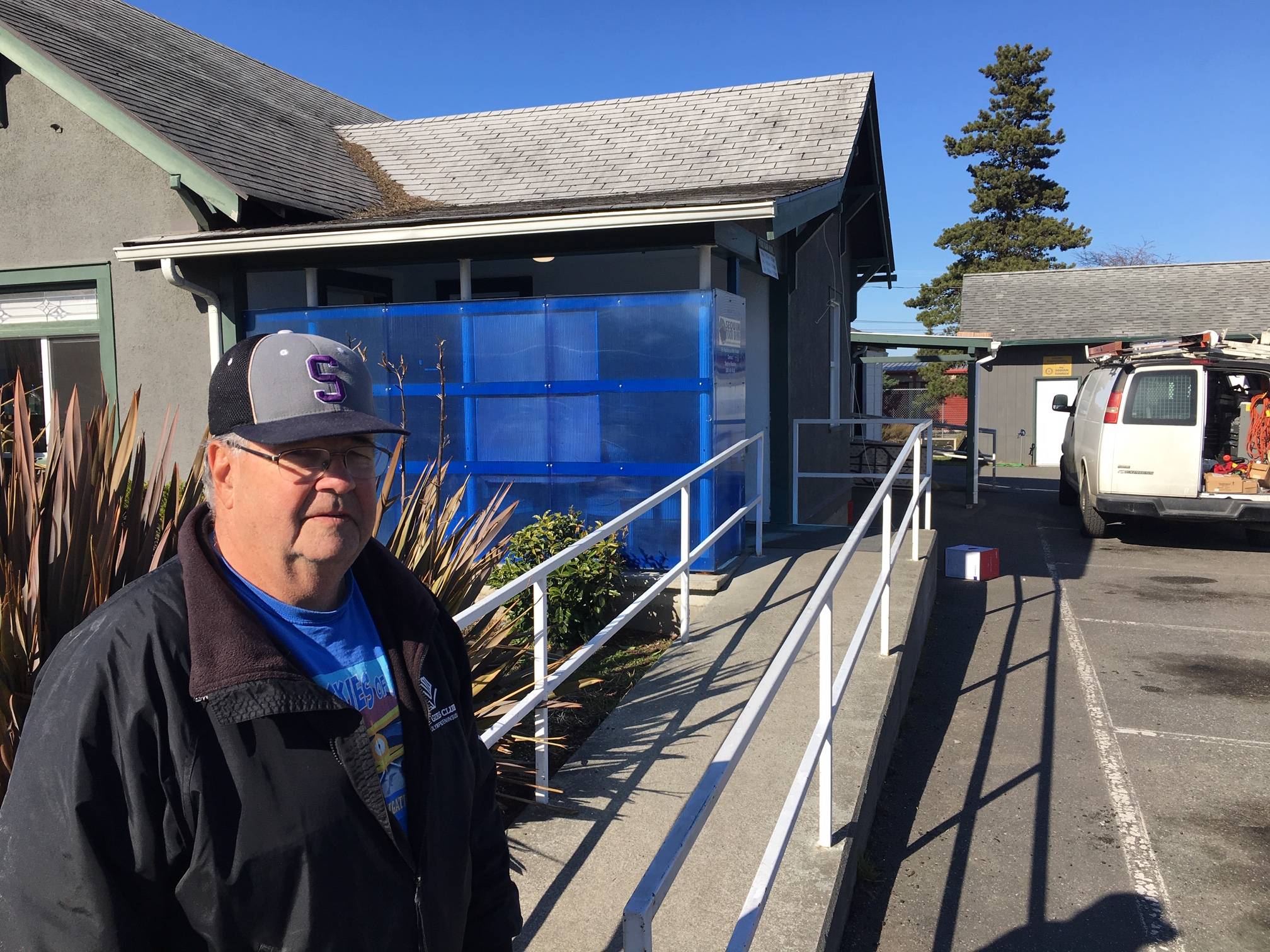 Stephen Rosales, president of the Sequim Food Bank board, stands outside the facility on Alder Street, where technicians with Security Services Northwest recently installed new security equipment. Photo courtesy of Security Services Northwest, Inc.