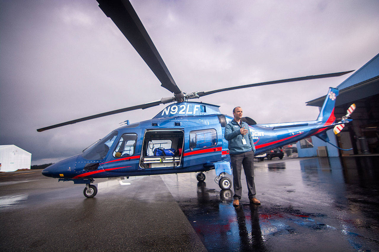 Jacob Dalstra, regional director for Life Flight Network, talks to firefighters during a training Saturday at William R. Fairchild International Airport in Port Angeles. (Jesse Major/Peninsula Daily News)