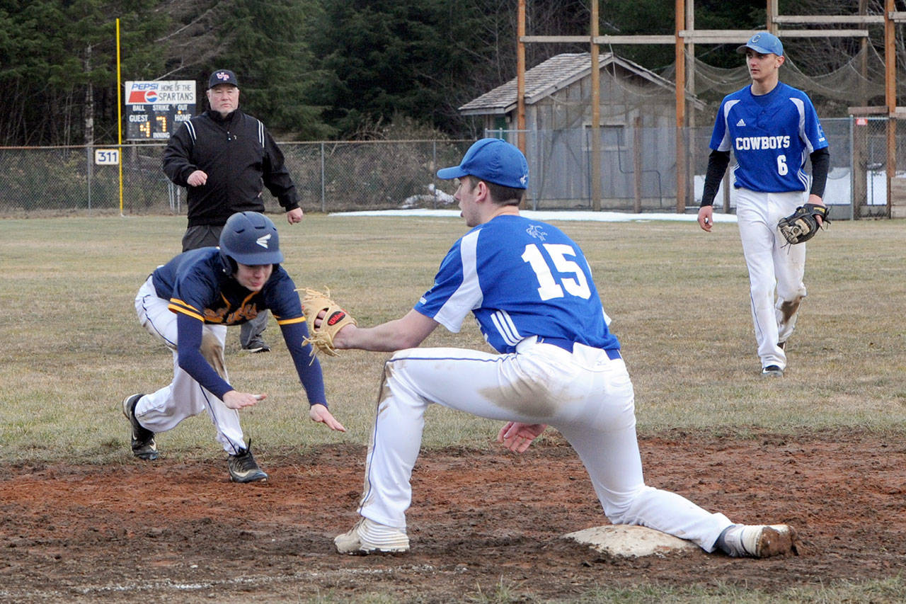 Spartan Joseph Reaume dives safely into third as Chimacum’s Wyatt Pennington (15) awaits the throw. Also in on the action is Chimacum’s Henry Brebberman (6). Forks won 6-5 in 10 innings. (Lonnie Archibald/for Peninsula Daily News)
