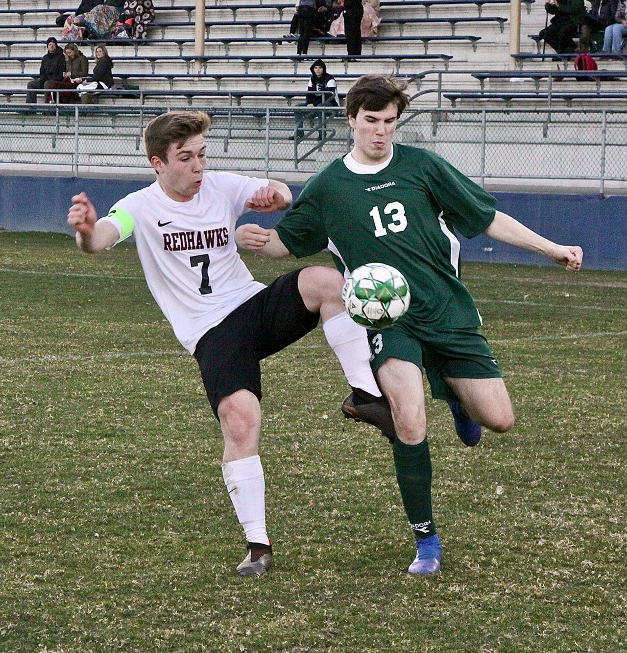 Port Townsends”s Ian Kjeldgaard, left, and Port Angeles’s Stuart Methner vie for possession Monday night at Civic Field. Dave Logan/for Peninsula Daily News