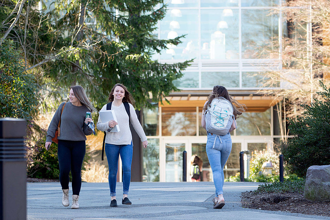Students walk between classes at Peninsula College on Wednesday. The college is considering layoffs as it looks to overcome a $800,000 deficit largely caused by decreasing enrollment. (Jesse Major/Peninsula Daily News)