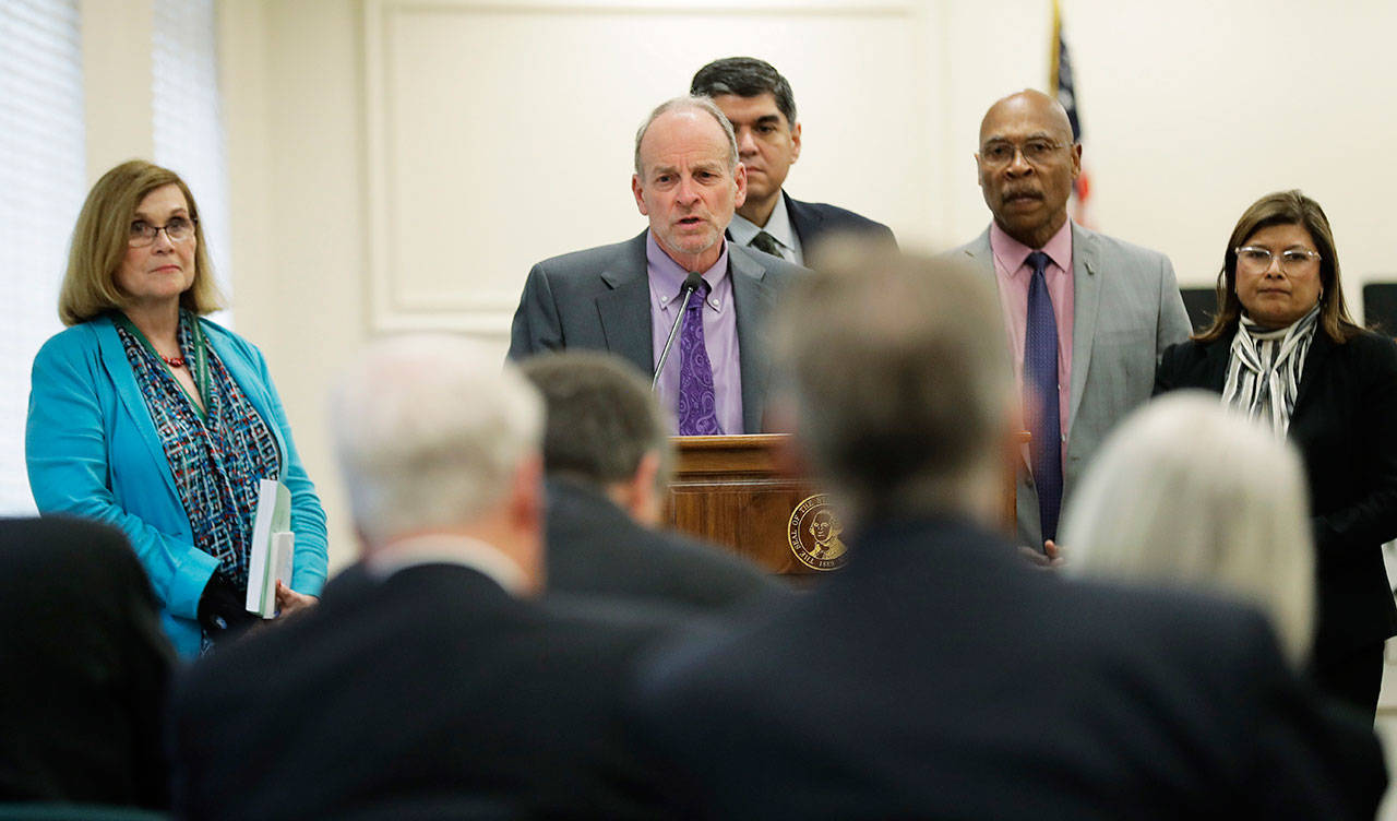 Rep. Jake Fey, D-Tacoma, center, chairman of the House Transportation Committee, talks to reporters Monday at the Capitol in Olympia. Democrats in the state House released their two-year transportation budget proposal Monday, which includes $9.9 billion in spending for projects. (Ted S. Warren/The Associated Press)