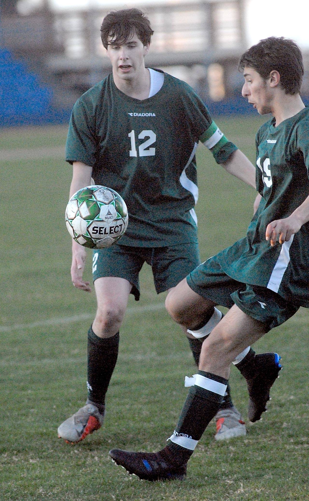 Keith Thorpe/Peninsula Daily News Port Angeles’ Andrew Methner, left, and Garrett Mahaney watch an incoming ball on Tuesday at Port Angeles Civic Field.