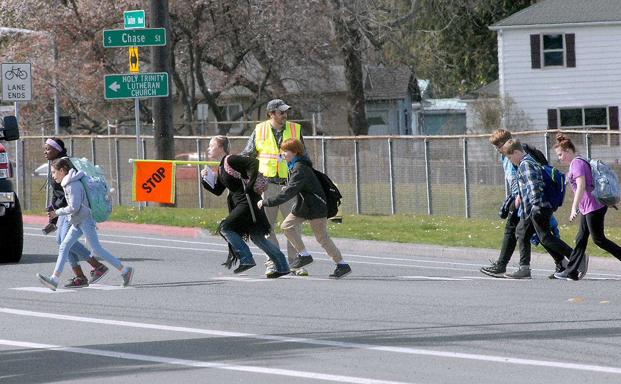 Crossing guard David Swan keeps watch as Jefferson School students cross Lauridsen Boulevard in Port Angeles on Thursday. (Keith Thorpe/Peninsula Daily News)