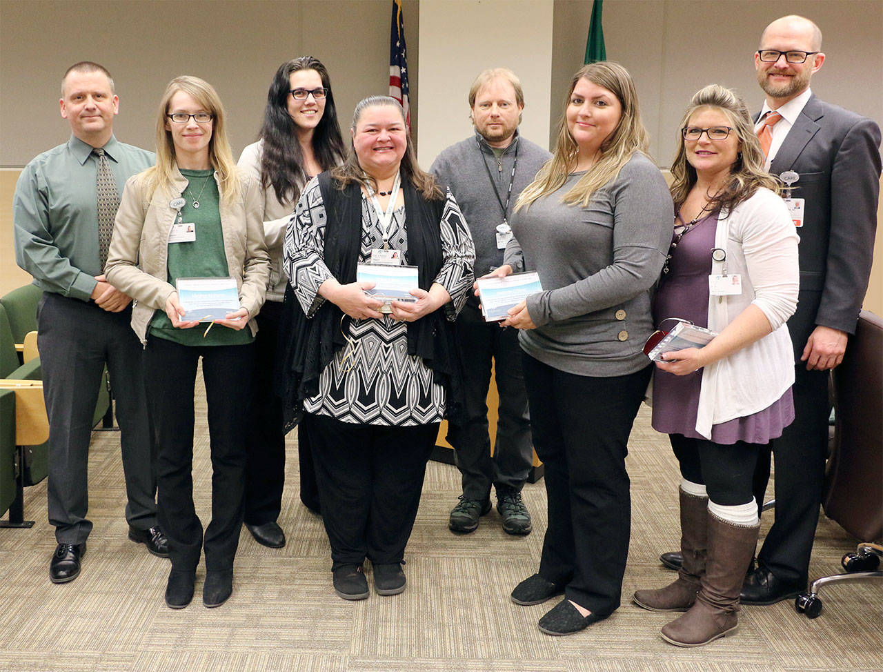 Pictured, from left, are Olympic Medical Center board President John Nutter; central access representatives Meghan McHenry, Alyssa Luciano, Tracy Camp, Bryan Bell, Melinda O’Neel and Nikki Brown; and Chief Physician Officer Dr. Josh Jones.
