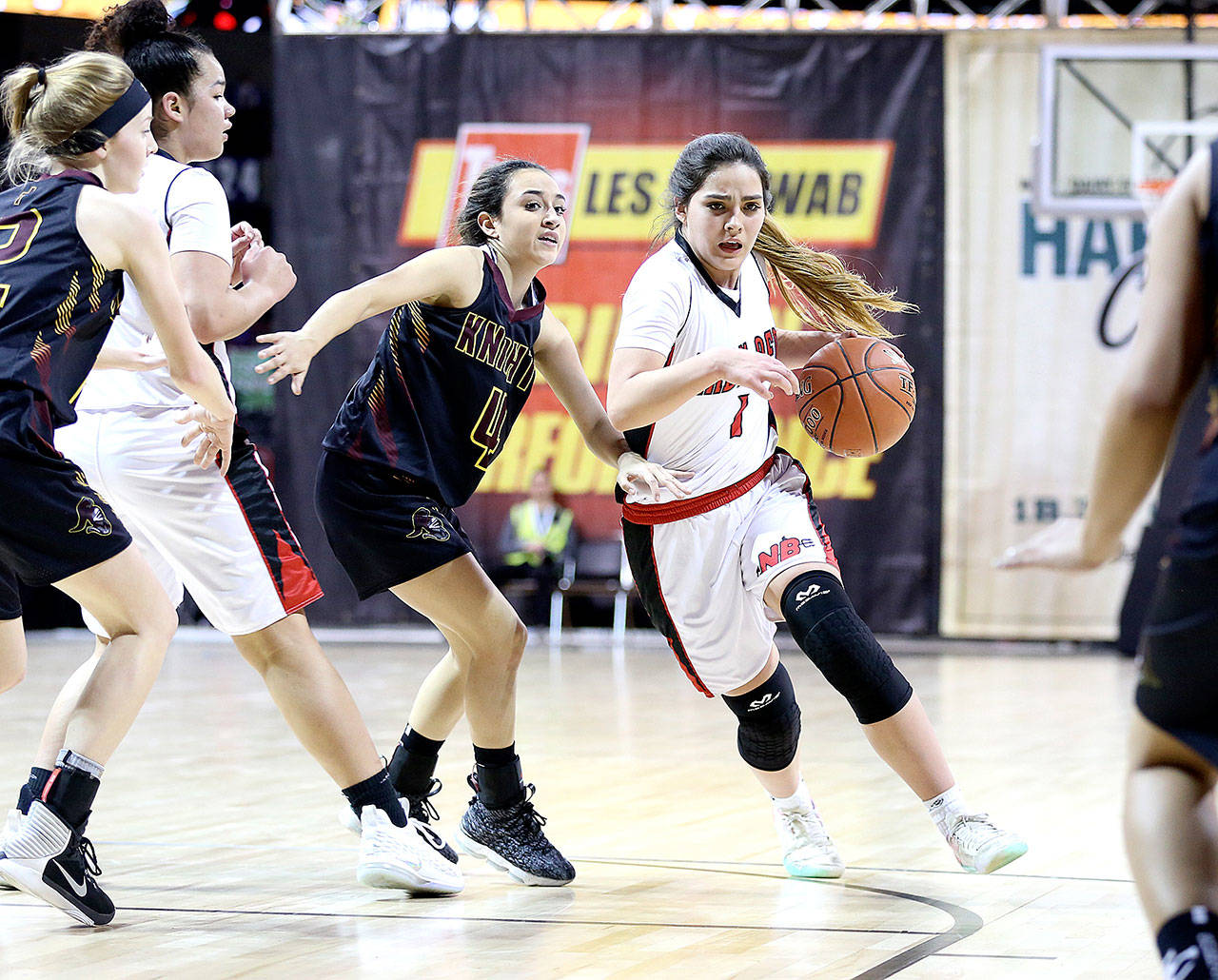 Chris Johnson/for the Peninsula Daily News Neah Bay’s Courtney Swan (1), here playing in the state 1B tournament in Spokane against Sunnyside Christian in February, was named to the Class 1B All-State Girls’ Basketball team.