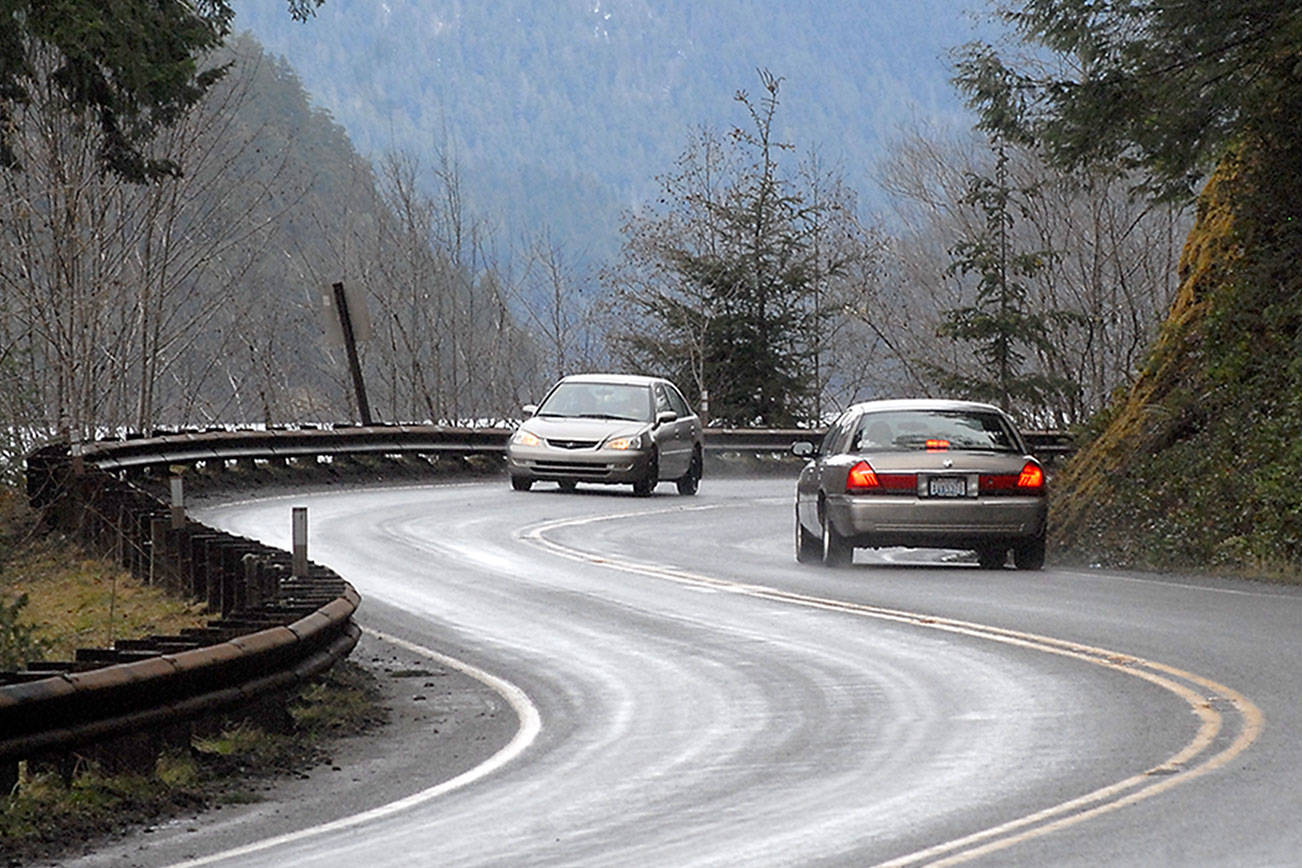 Keith Thorpe/Peninsula Daily News Cars make their way around a curve on U.S. Highway 101 at Lake Crescent west of Port Angeles on Wednesday.