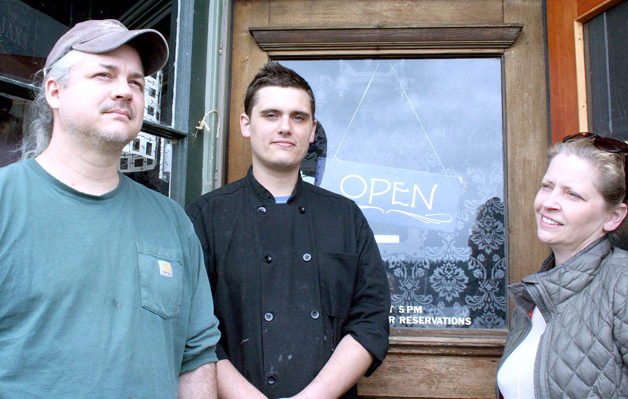 From left, Bill Bonyun, Graham Welch and Kristan McCary were in the final stages of preparations Friday before the reopening of the Ajax Cafe, 21 N. Water St. in Port Hadlock. (Brian McLean/Peninsula Daily News)