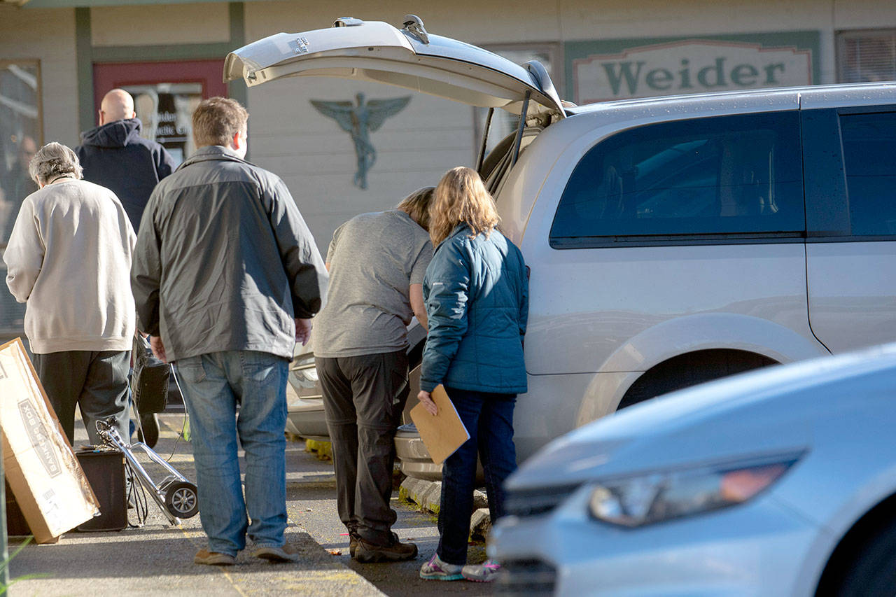 Federal agents serve a search warrant at Certified Medical Supply Inc., 603 E. Eighth St., in Port Angeles on Tuesday morning. (Jesse Major/Peninsula Daily News)