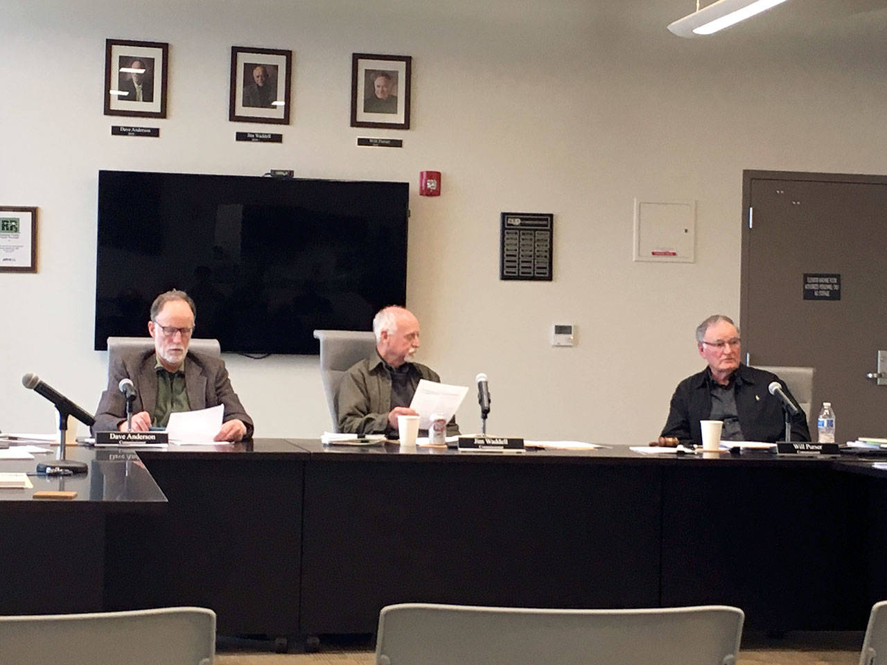Clallam County Public Utility District commissioners David Anderson, left, Jim Waddell and Will Purser listen to a staff report during their meeting in Carlsborg on Monday. (Rob Ollikainen/Peninsula Daily News)