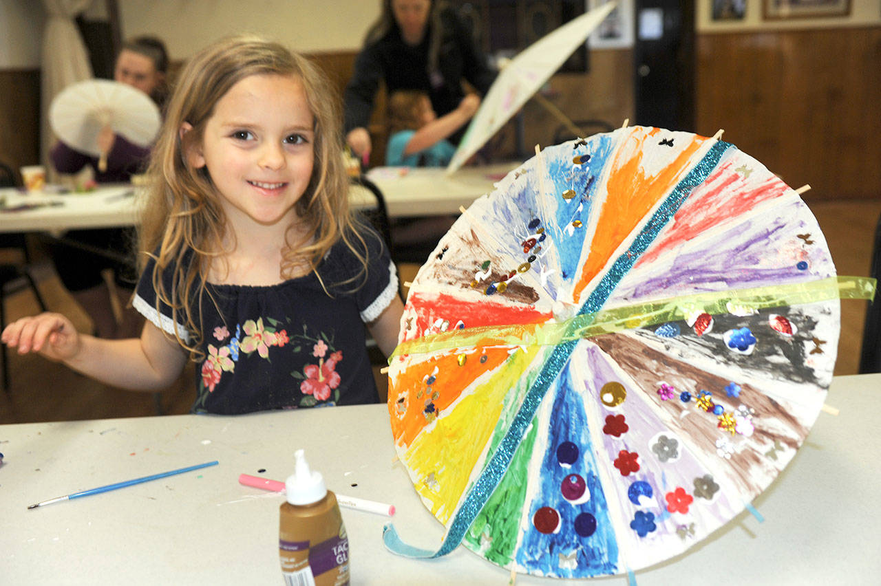 Eliza Dargitz, 5, of Forks decorates her umbrella at the Forks Elks Lodge during the first weekend of Forks Rainfest. The festival’s second weekend begins tonight. (Lonnie Archibald/for Peninsula Daily News)