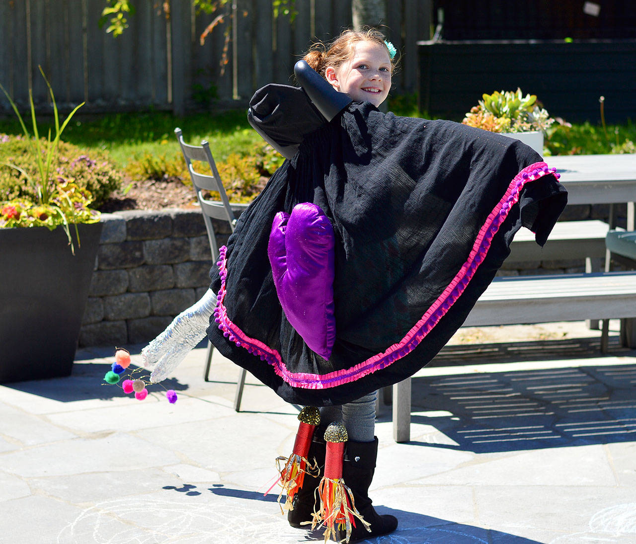 In her Wearable Art Show entry, Macy Little readies for takeoff from her Port Townsend backyard.