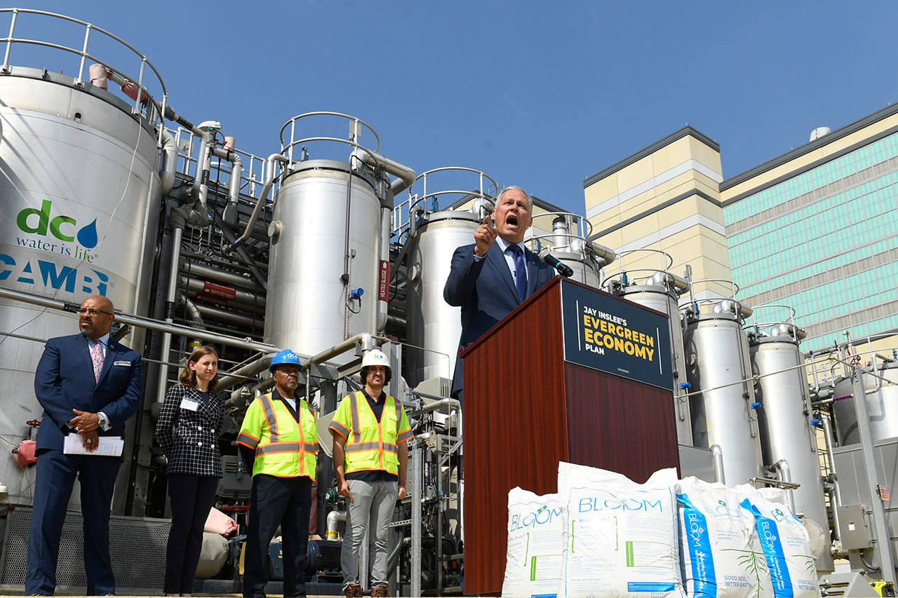 Democratic presidential candidate Gov. Jay Inslee, center, speaks during an event at the Blue Plains Advanced Wastewater Treatment Plant in Washington, D.C., on Thursday during an event where he unveiled part of his plan to defeat climate change. (Susan Walsh/The Associated Press)