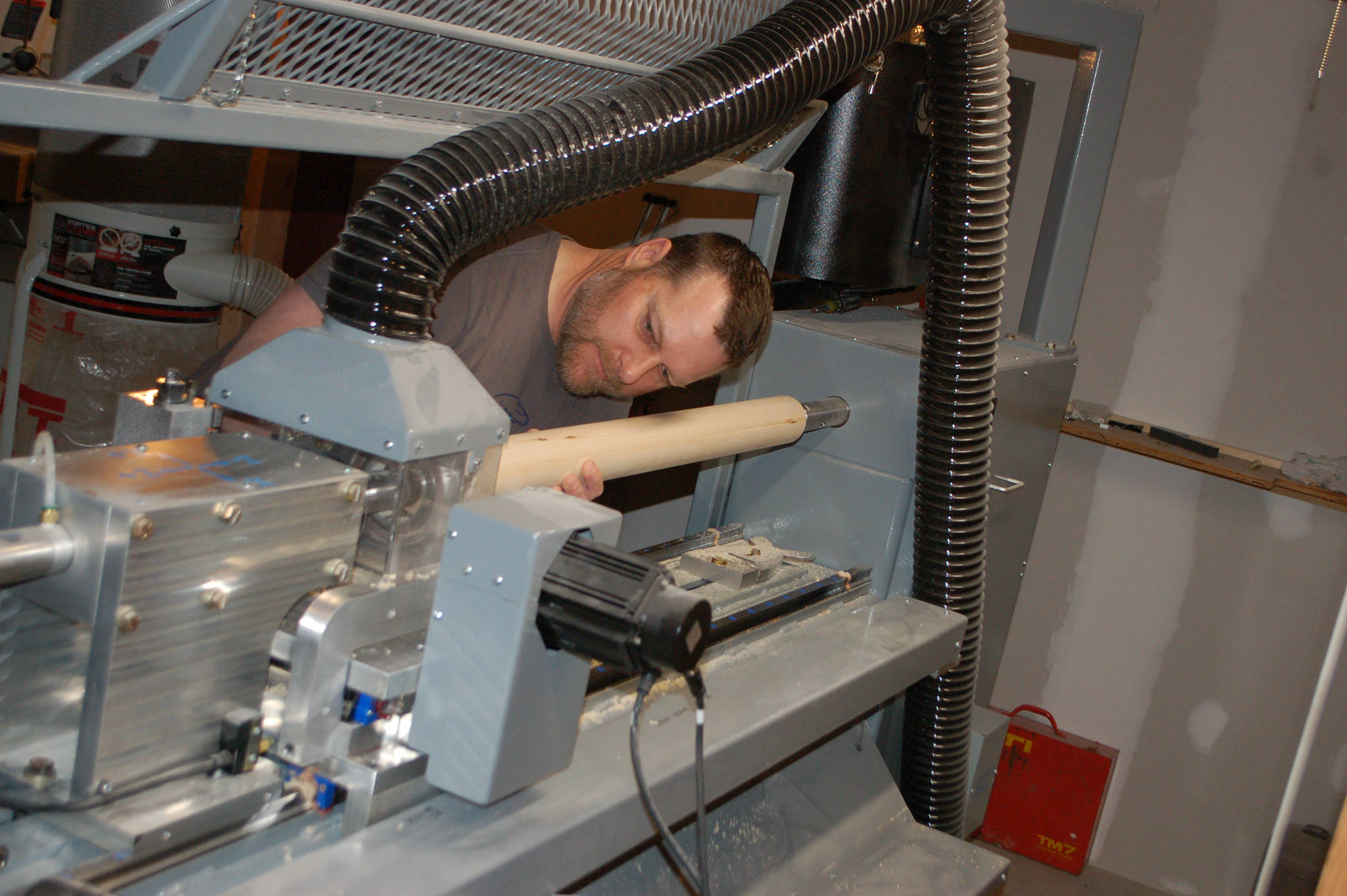 Tsunami Bats owner Gary White prepares a billet to be turned on his lathe to become his next bat. Conor Dowley/Olympic Peninsula News Group.