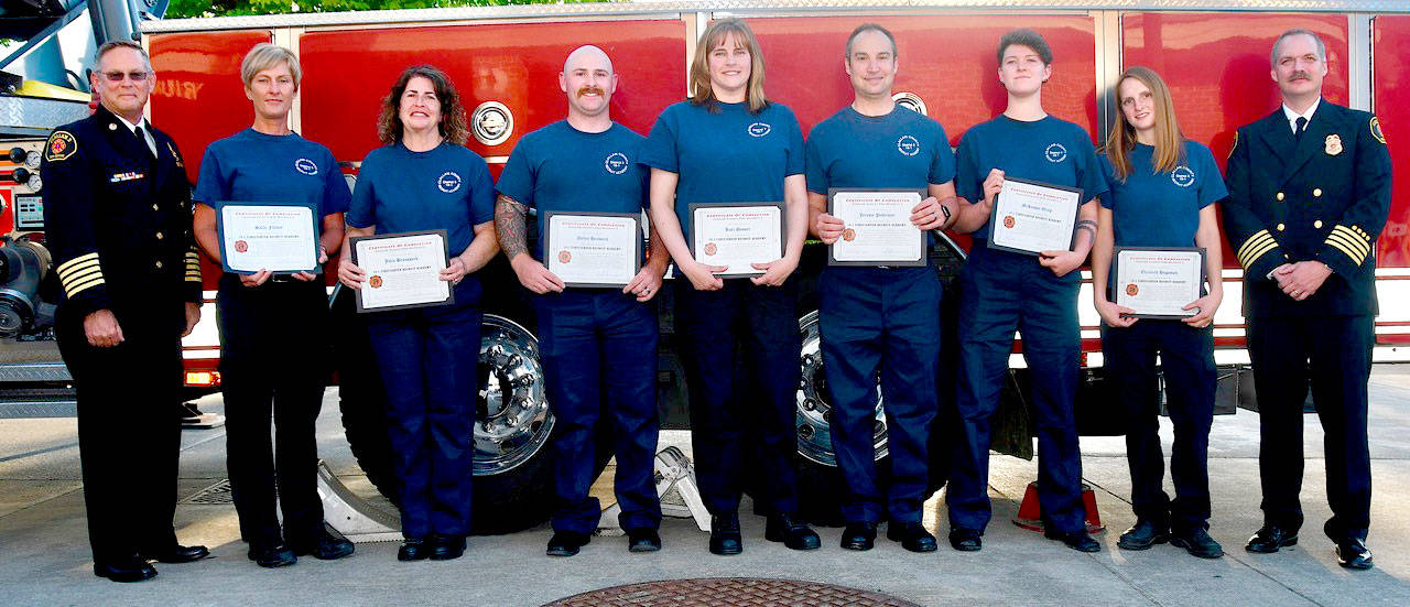 (Photo by Jay Cline)                                Pictured from left, Fire Chief Sam Phillips with new graduates Sally Fulton, Julie Broussard, Dylen Heaward, Kari Desser, Jeremy Pederson, McKensie Griep and Elizabeth Hagaman and Deputy Fire Chief Jake Patterson.