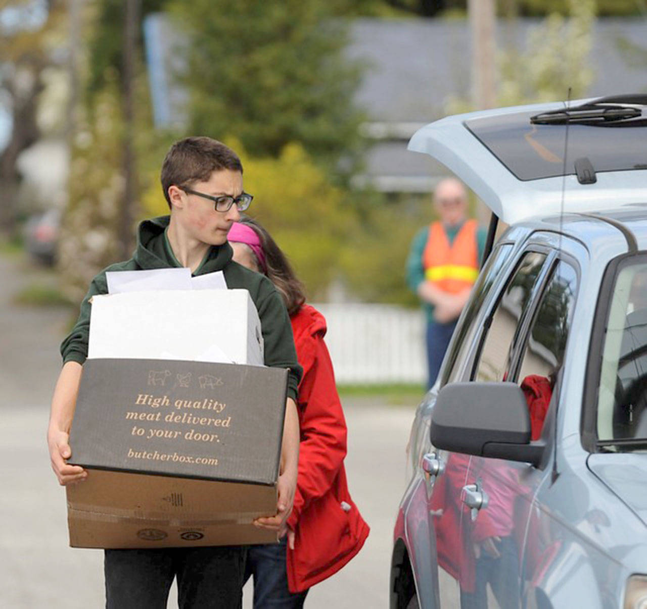 Port Angeles High School NJROTC cadet Harrison Fulton assists with collecting material to be shredded during a recent fundraiser.