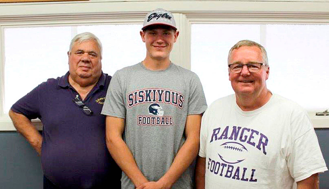 From left, Byron Wilson, Quilcene assistant head football coach Byron Wilson, Robert Comstock III and head football coach Trey Beathard were at Comstock’s signing last week to play football at College of the Siskiyous in Weed, Calif.