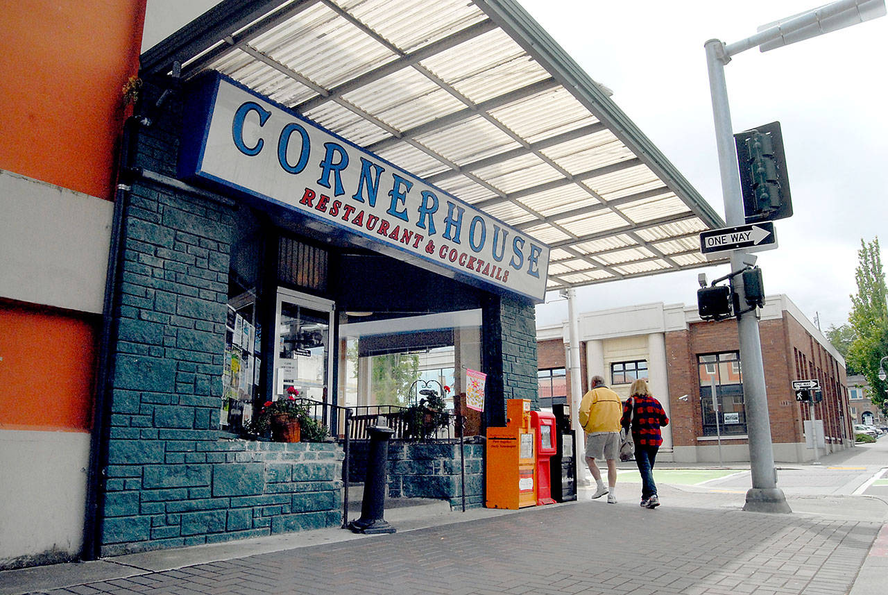 Pedestrians walk past the Cornerhouse restaurant at Front and Laurel streets in downtown Port Angeles on Thursday. The restaurant could be demolished beginning in September for the Lower Elwha Klallam Tribe’s new downtown Port Angeles hotel, but it’s not likely it will happen that soon, the project manager said. (Keith Thorpe/Peninsula Daily News)