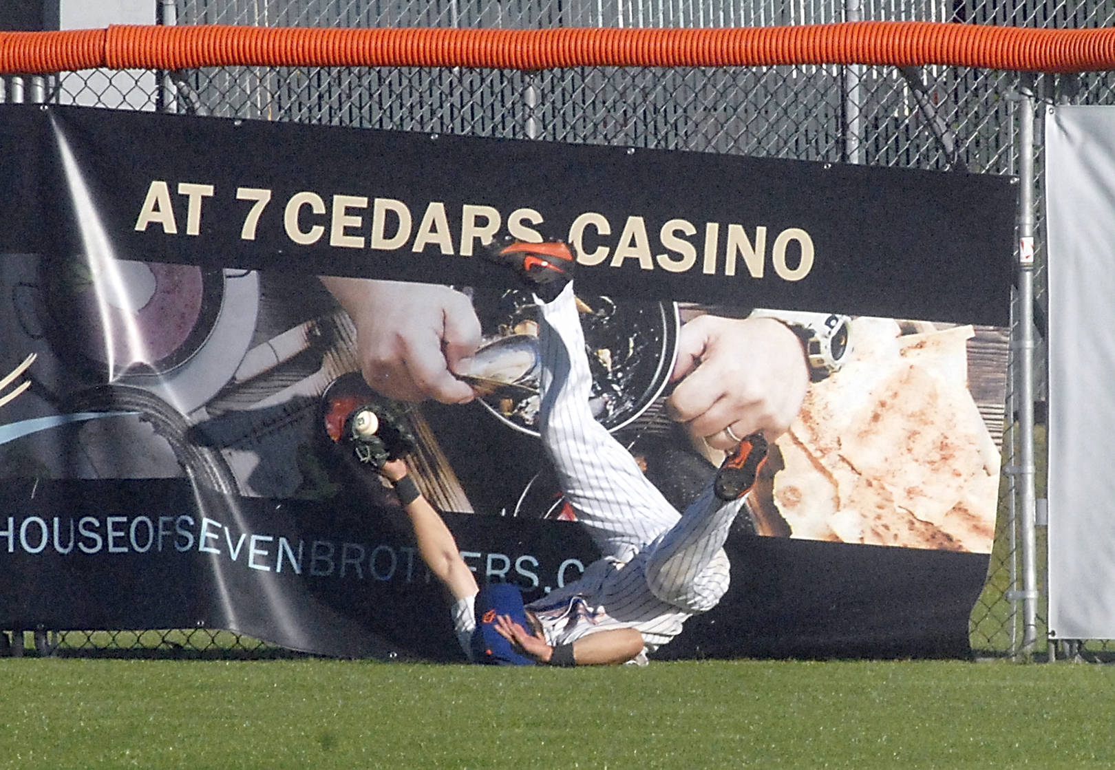 <strong>Keith Thorpe</strong>/Peninsula Daily News Lefties centerfielder Ronnie Rust tumbles to the ground after crashing into the fence fielding a long fly ball in the second inning against the Bellingham Bells on Friday at Port Angeles Civic Field.