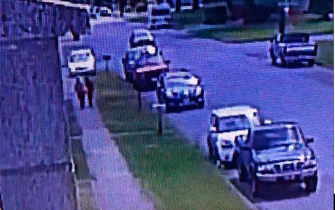 Surveillance footage showing a van apparently driving at two people walking on a sidewalk in Port Angeles.