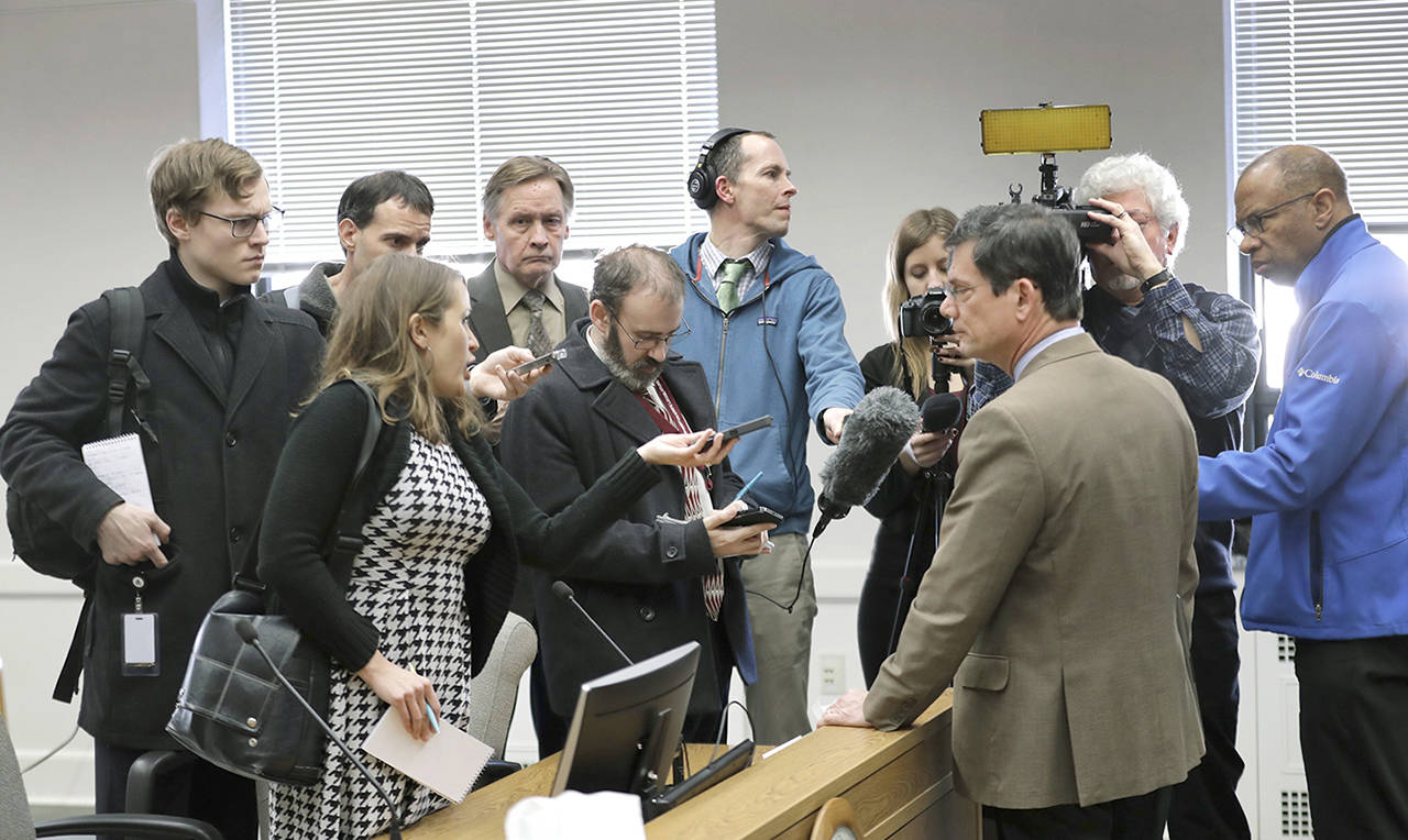 In this file photo, reporters talk with Sen. Mark Miloscia, R-Federal Way, third from right, following a joint work session of the Senate and House State Government Committees on Feb. 22, 2018, at the Capitol in Olympia. The session was held to discuss a bill filed by lawmakers who wanted to circumvent a court ruling finding them fully subject to the state’s public disclosure laws. (Ted S. Warren/The Associated Press)