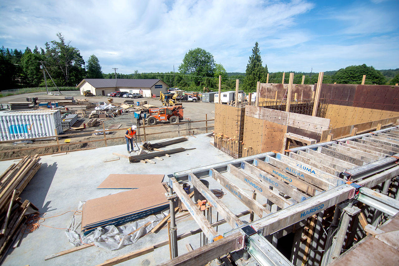 Konnor Parrish, an intern with Swinerton construction, moves wall-reinforcing steel at the construction site of the new hotel at 7 Cedars Casino on Wednesday. (Jesse Major/Peninsula Daily News)