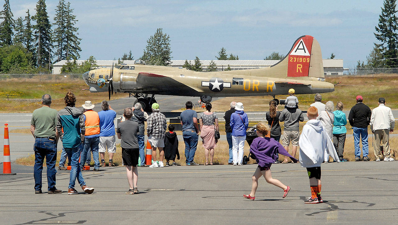 A World War II-era B-17 bomber takes off as a crowd watches at William R. Fairchild International Airport in Port Angeles in 2017 during a stop on the Wings of Freedom tour of vintage war planes. (Keith Thorpe/Peninsula Daily News)