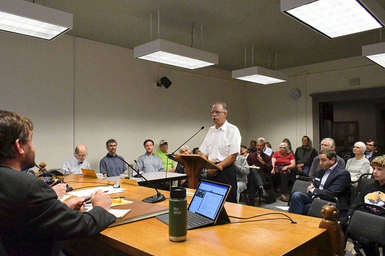 A crowd turned out Monday at the Jefferson County Commissioners meeting to hear public testimony about creating a new segment of the Olympic Discovery Trail from Four Corners Road to Anderson Lake State Park. Jeff Michaelson, at podium, said he was concerned that the trail was going to run along his property and he had issues with security. (Jeannie McMacken/Peninsula Daily News)