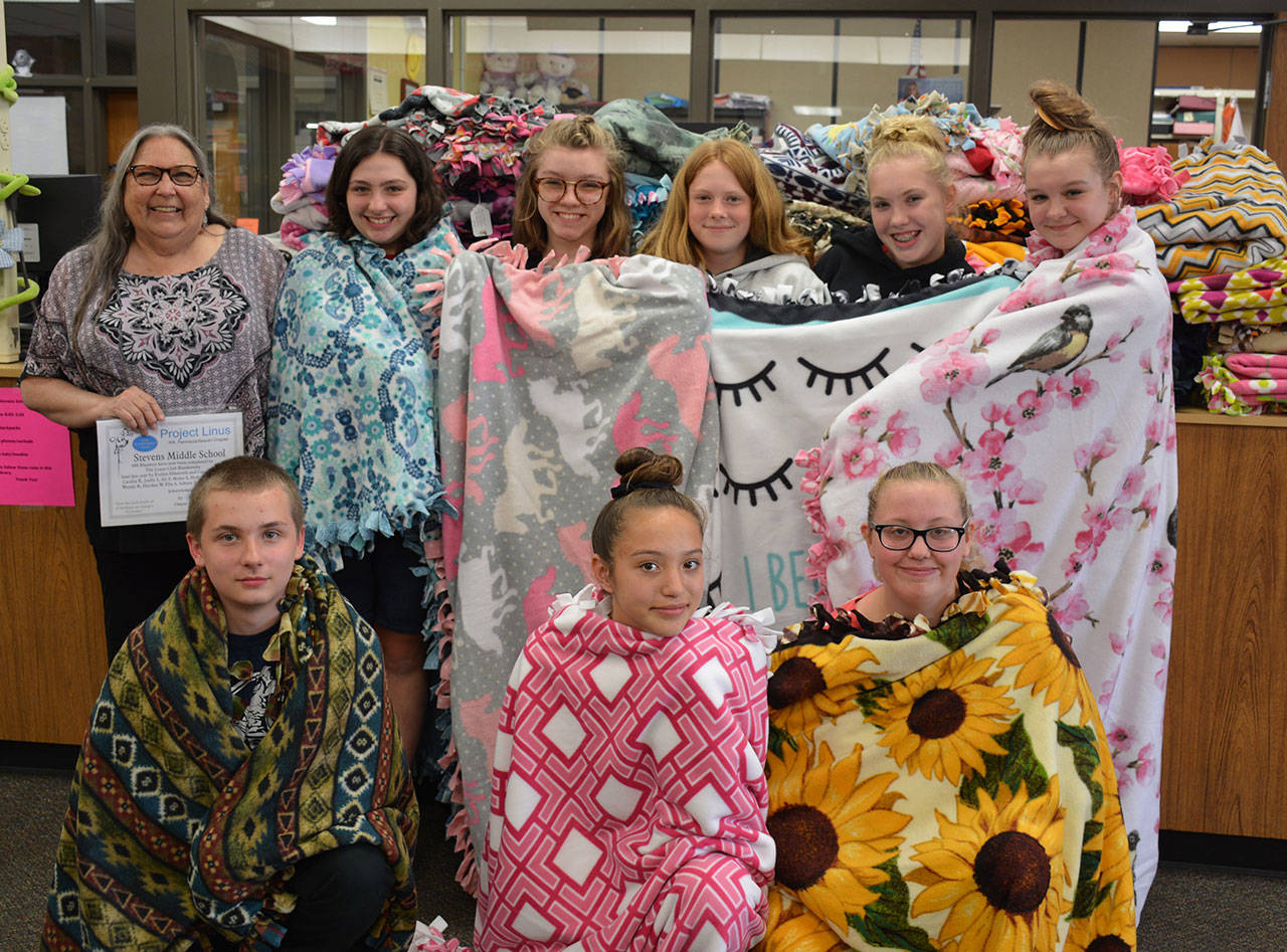 Standing, from left, are Project Linus advisor Evelyn Ellsworth with club members Allison Pettit, Jordis Vance, Ella Siler, Adisyn Ellis-Bourm and Hayden Webber. Kneeling, from left, are club members Brinnon Fowler, Holli Clark and Mylee Soiseth. Community volunteer Carol Hughes is not pictured. (Patsene Dashiell/Port Angeles School District)