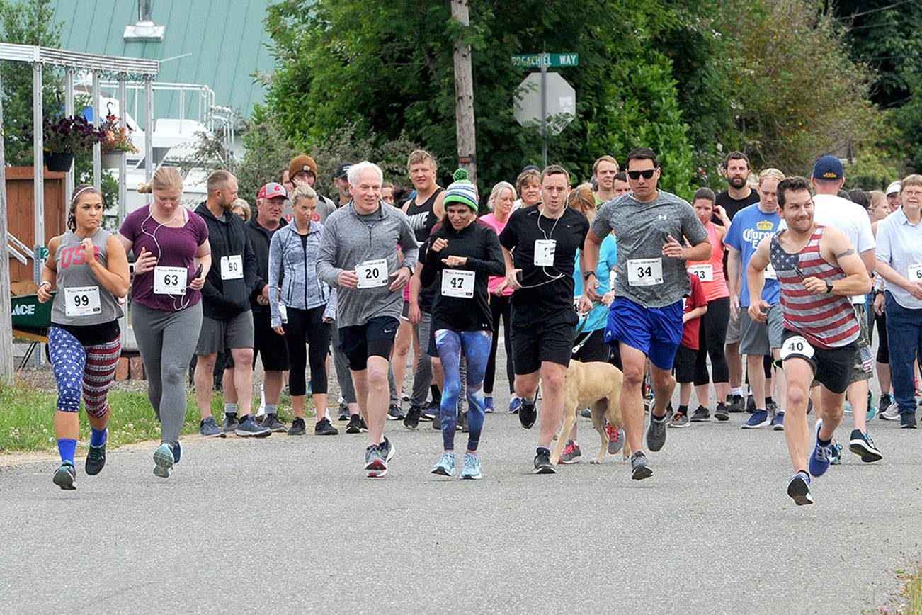 Levi Larson (40) far right of Forks was quick off the starting line Saturday during the Forks Fourth of July Fun Run in the 10K group. Larson finished first while Adison White of Utah placed first in the 5K. Approximately 75 runners and walkers participated in the annual race organized by Forks varsity basketball coach Rick Gooding to benefit the Forks High School basketball program. (Lonnie Archibald/for Peninsula Daily News)