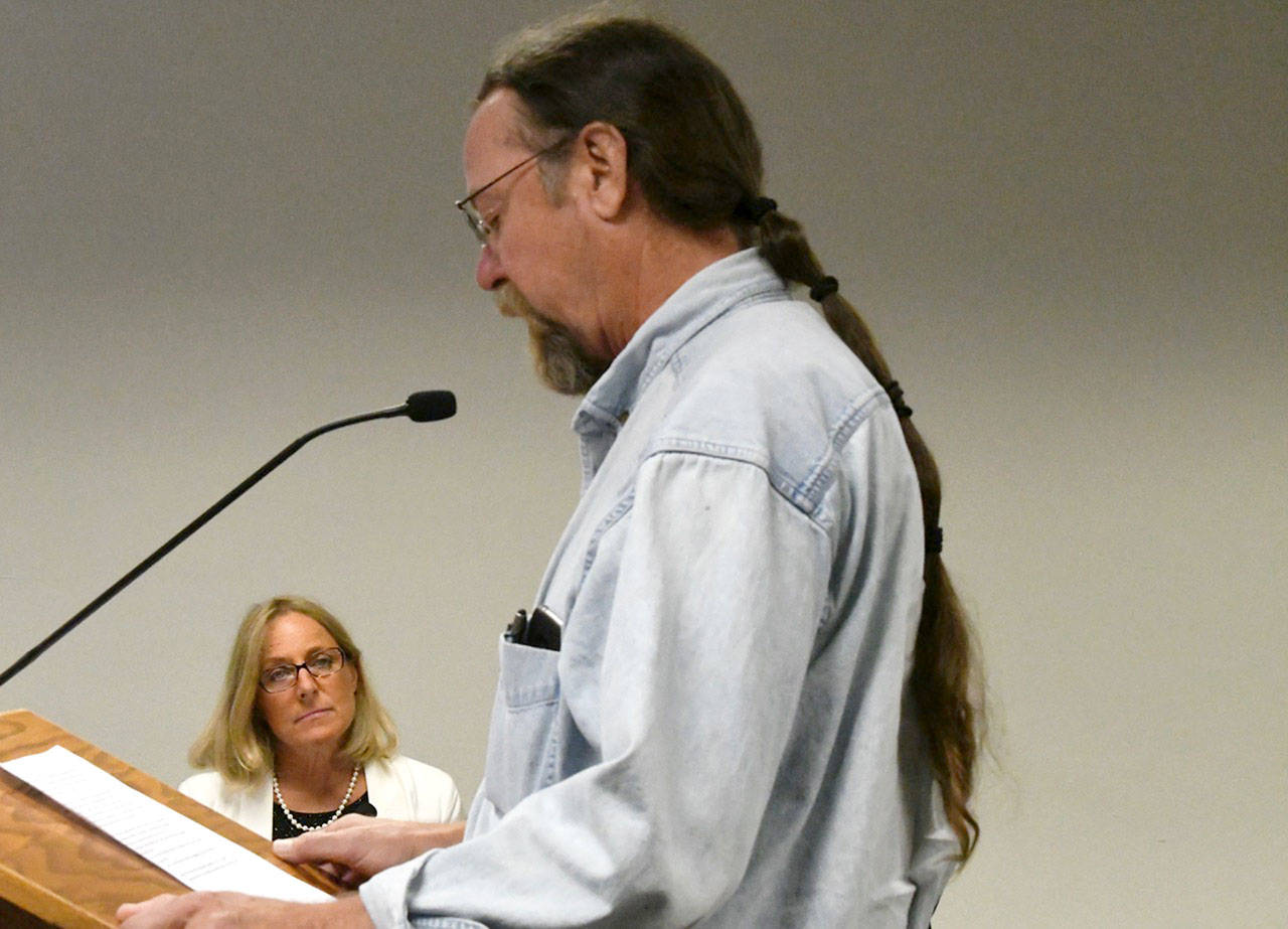 Patty Charnas, director of Jefferson County Department of Community Development, listens as Rob Mitchell of Brinnon provides testimony at Monday’s Pleasant Harbor Resort public hearing. (Jeannie McMacken/Peninsula Daily News)
