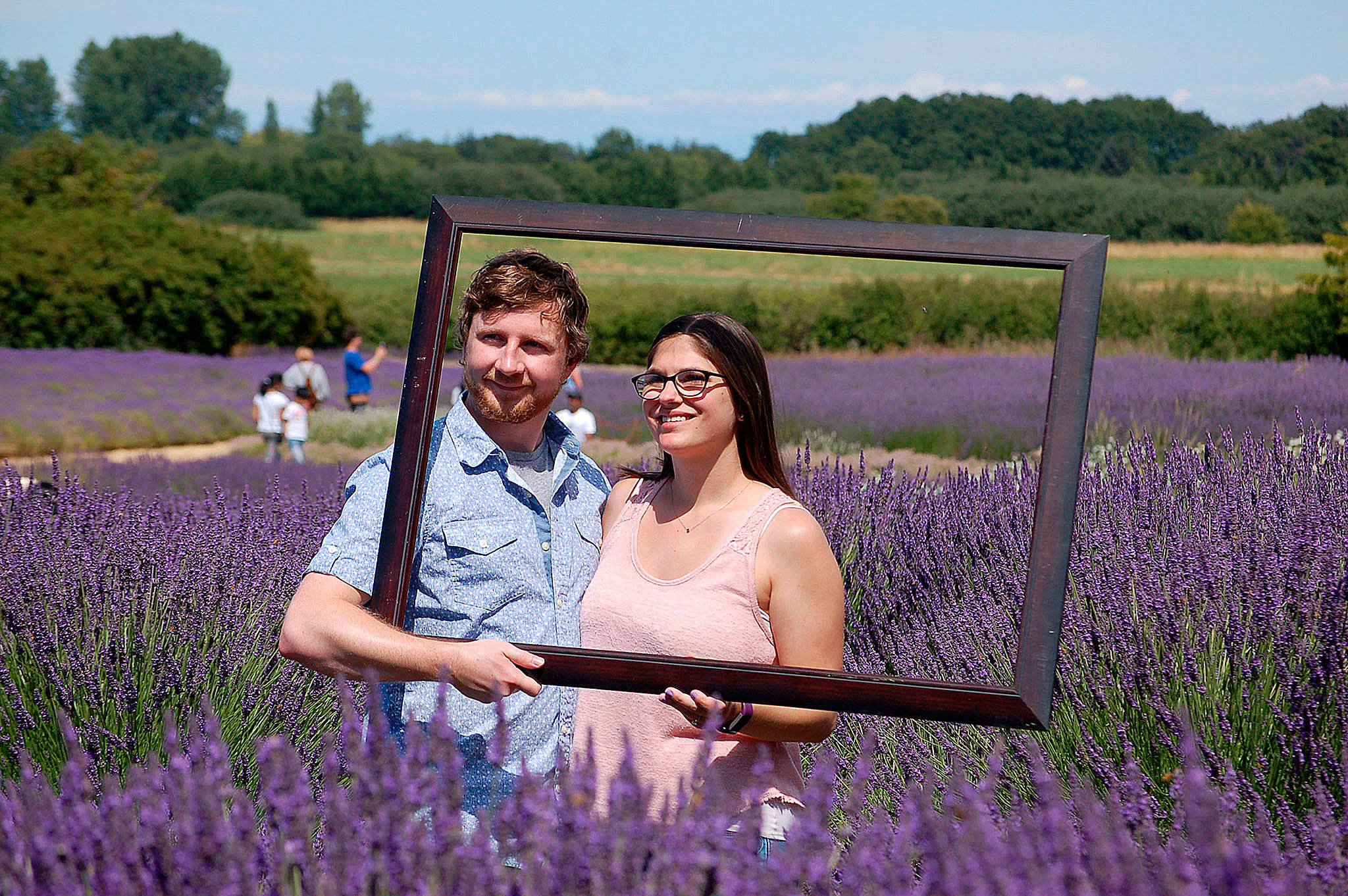 Michigan couple Nathan and Olivia Mckay set up a photo at Jardin du Soleil Lavender Farm in July 2018. The farm continues to offer free photos as part of its Jardin du Soleil Lavender Festival. (Erin Hawkins/Olympic Peninsula News Group)