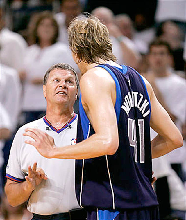 The Associated Press Former NBA player and longtime referee Bernie Fryer, left, explains a call to Dirk Nowitzki of the Dallas Mavericks. Fryer, a Port Angeles High School and Peninsula College alumn, will be inducted into the State of Washington Sports Hall of Fame next month.