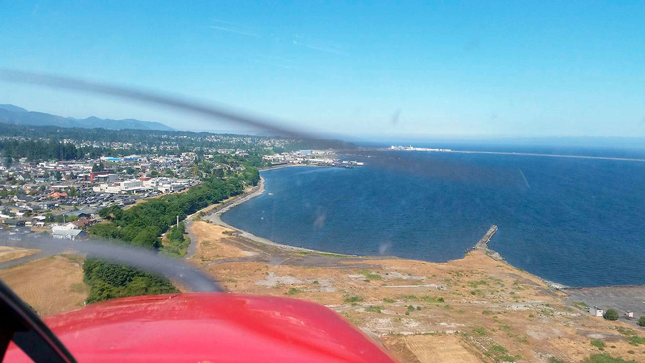 An aircraft approaches Port Angeles from just east of the former Rayonier mill site. Seaplanes would land in the harbor. (Port of Port Angeles)
