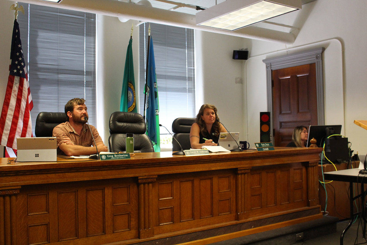 Jefferson Board of County Commissioners Greg Brotherton and Kate Dean listen to an overview summary of the Chimacum School District by Superintendent Rick Thompson at their Monday meeting. (Zach Jablonski/Peninsula Daily News)