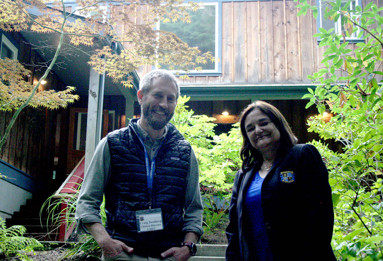 Newport Academy Clinical Director Craig Isenberg, left, and Dr. Barbara Nosal, the academy’s chief clinical officer, stand in front of the main building on the campus formerly known as Gray Wolf Ranch in Jefferson County. Newport Academy acquired the property in June and reopened it Aug. 1. (Brian McLean/Peninsula Daily News)