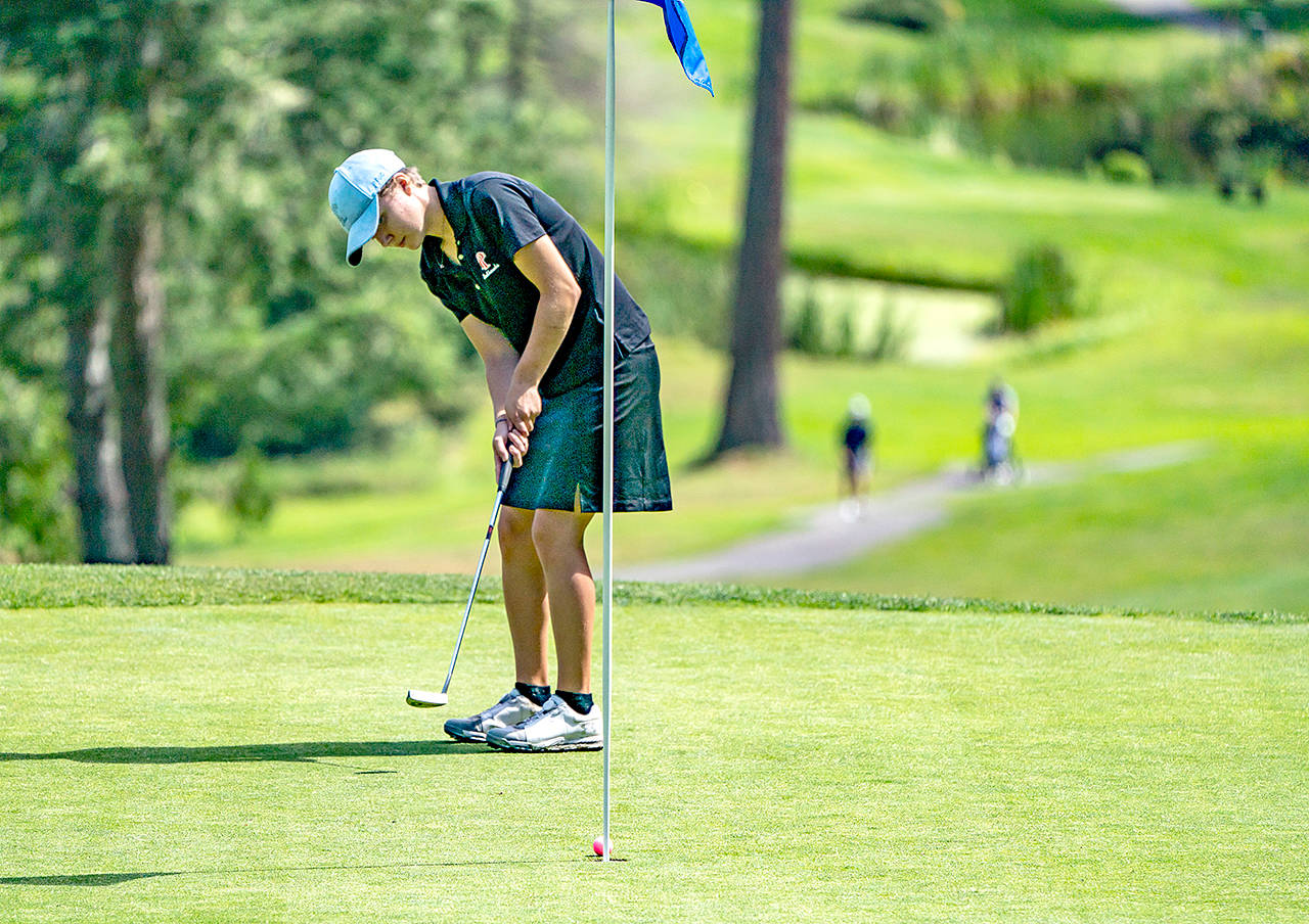Port Townsend’s Mackenzie Lake sinks a 6-foot put on the 18th green during the Pacific Northwest Golf Association’s Girls Junior Amateur Championship at Port Ludlow Golf Course on Monday. Steve Mullensky/for Peninsula Daily News