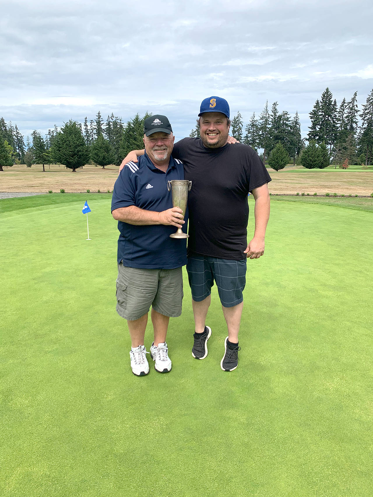 Peninsula Golf Club’s Paul Reed, left, teamed with his son Todd to win the club’s annual Member-Guest Tournament. The Reed’s shot a gross 133 to beat Jade Tisdale and Curtis Rose and Jeremy Copeland and Sid Krump by seven strokes. Photo by: Peninsula Golf Club