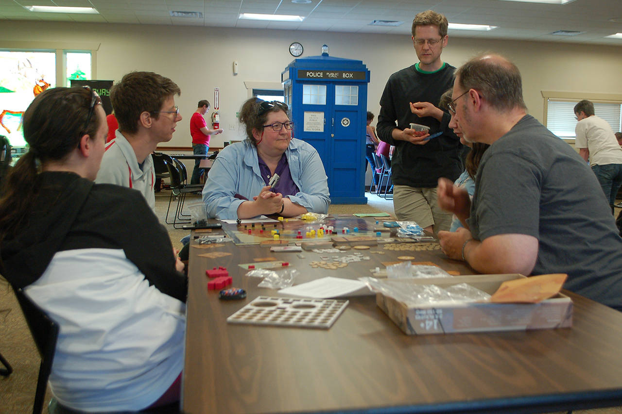 <strong>Conor Dowley</strong>/Olympic Peninsula News Group Several people from Sequim and Port Angeles work together to learn a new game at Opttacon 2019 at the Guy Cole Event Center.