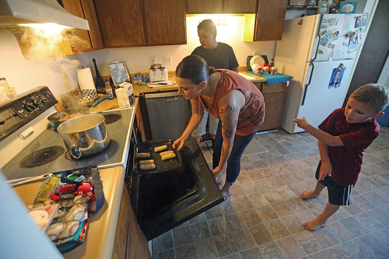 Misty Dotson prepares dinner for her sons at their home Tuesday in Murray, Utah. Dotson is a 33-year-old single mother of two boys, ages 12 and 6, who goes to Planned Parenthood for care through the Title X program. Dotson is among the 39,000 people who received treatment from Planned Parenthood of Utah in 2018 under a federal family planning program called Title X. The organization this week announced it is pulling out program rather than abide by a new Trump administration rule prohibiting clinics from referring women for abortions. (Rick Bowmer/The Associated Press)