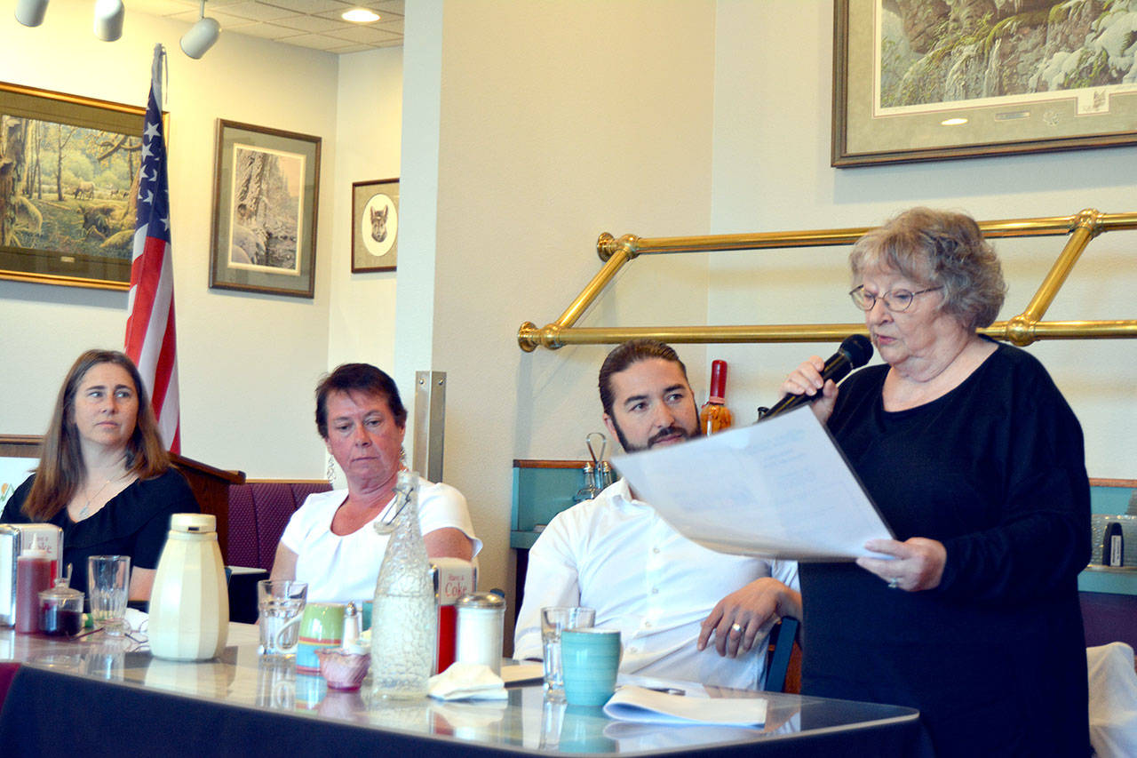 Port Angeles School Board candidate Sandy Long, standing, explains elements of the school district’s strategic plan Tuesday at a voters forum that included candidates, seated left to right, Katie Marks, Arwen Rice and Jacob Wright. (Paul Gottlieb/Peninsula Daily News)