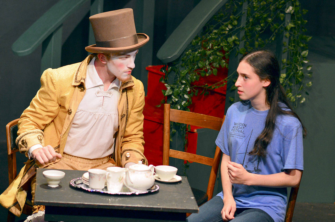 The Mad Hatter (Orion Pendley) mystifies Alice (Grace Wentzel) in “Alice in Wonderland,” the Teen Initiative production at Port Townsend’s Key City Public Theatre this weekend. (Diane Urbani de la Paz/for Peninsula Daily News)