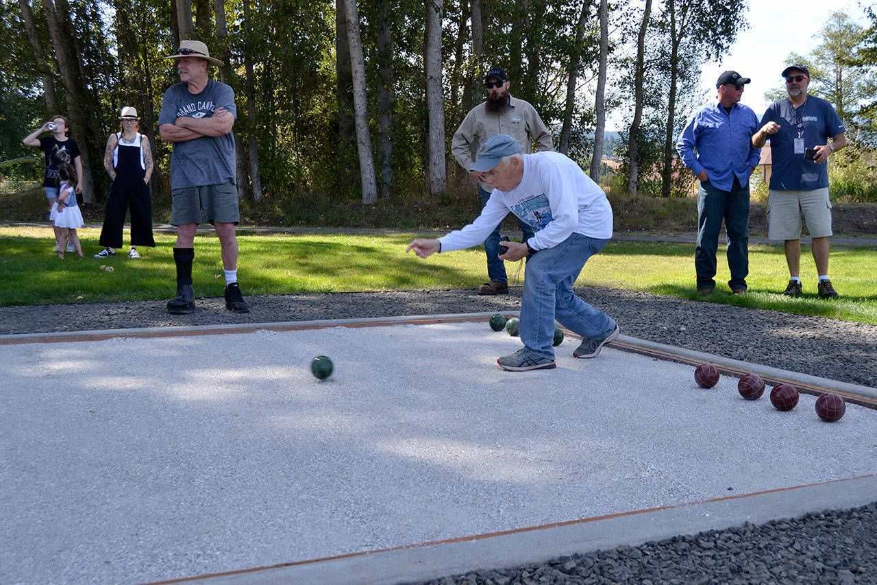 David Stahl rolls a bocce ball to help open play on the new court in Carrie Blake Community Park on Wednesday. (Matthew Nash/Olympic Peninsula News Group)