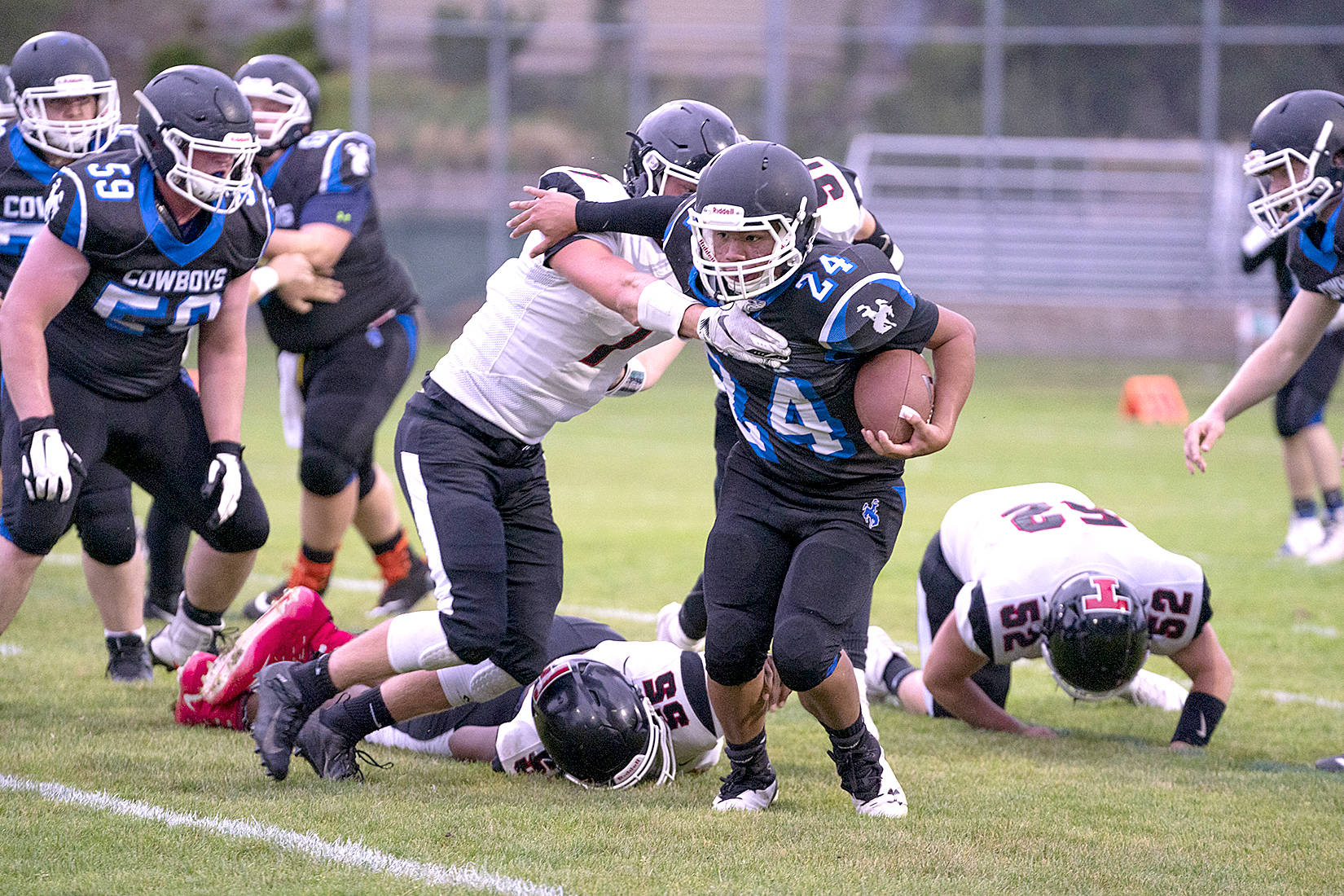 <strong>Steve Mullensky</strong>/for Peninsula Daily News Chimacum’s Anson Jones in the Cowboys’ new black uniforms runs for yardage in a game against the Tenino Beavers on Friday at Memorial Field in Port Townsend.