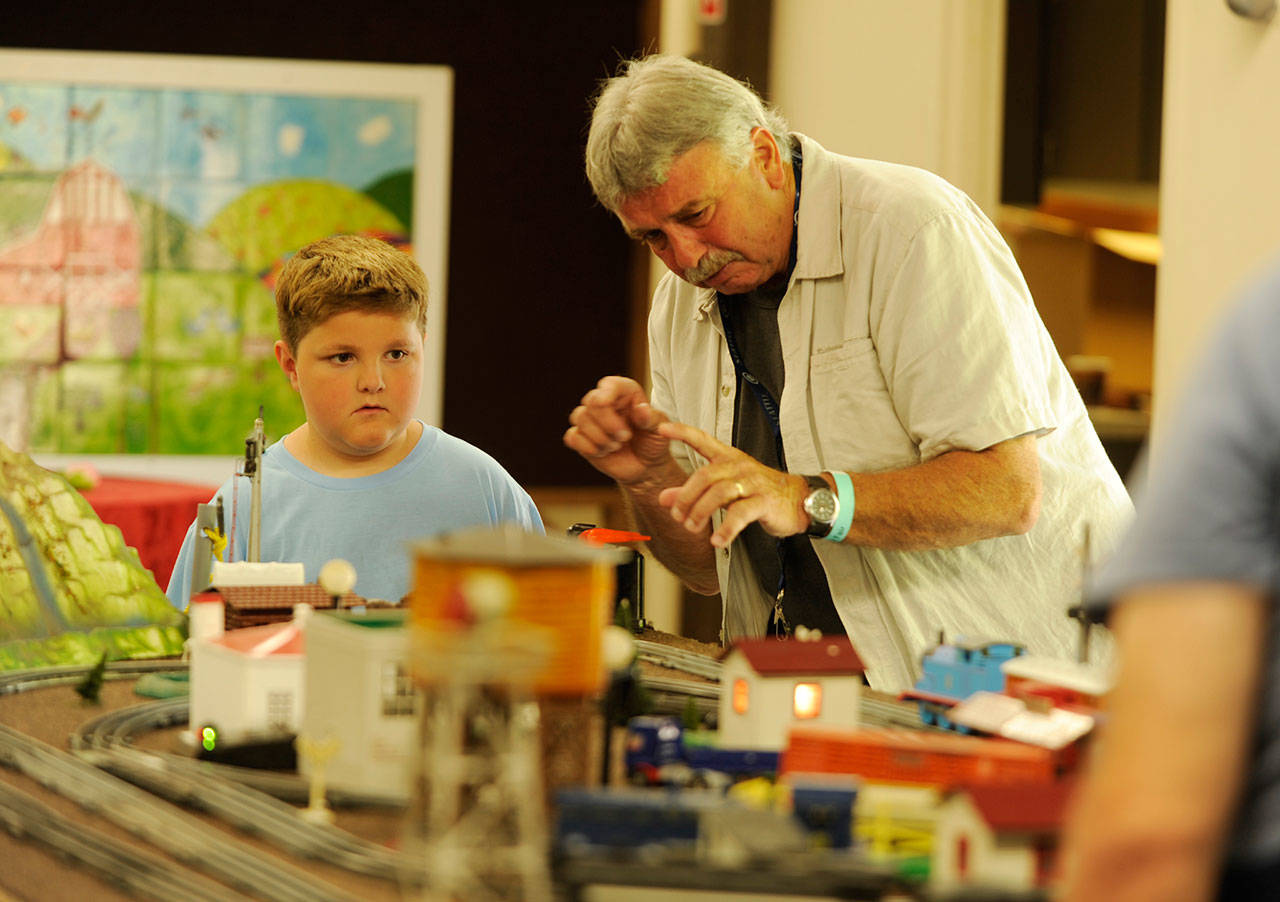 Nathaniel Baze, 7, at left, talks with Steve Dryke of the North Olympic Railroaders group at the Clallam County Fair in August. The club returns to the fairgrounds this weekend for its 20th annual show. (Michael Dashiell/Olympic Peninsula News Group)