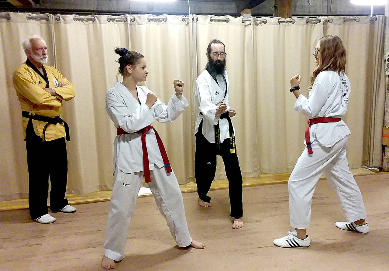 From left, Grandmaster Robert Nicholls of White Crane Martial Arts, Ava Reymond, Robert Nicholls and Scarlett Fulton, are all traveling to Korea next week as Reymond and Fulton are testing for their taekwondo black belts and the grandmaster Nicholls is seeking to become the technical director of the World Taekwondo Federation. (Pierre LaBossiere/Peninsula Daily News)