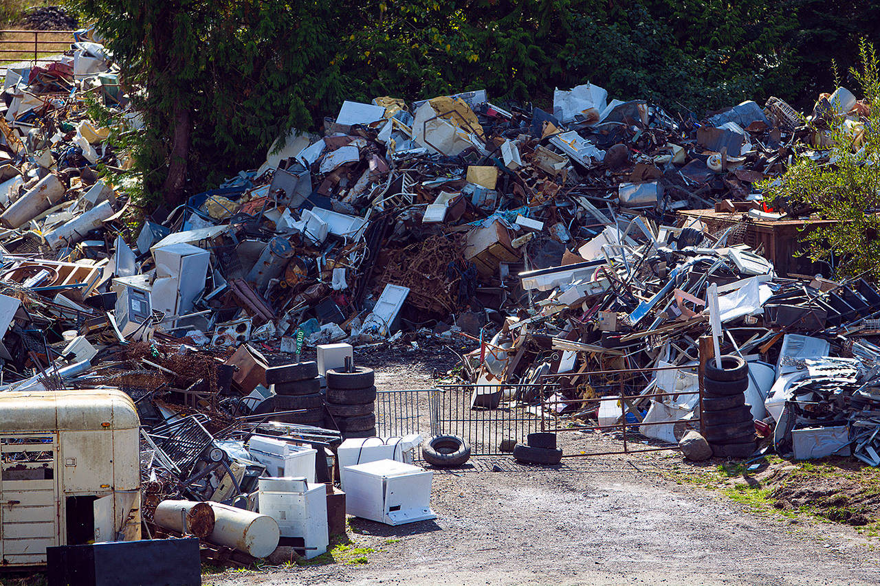 A gate made of metal panels blocks the entrance to Midway Metals between Sequim and Port Angeles. (Jesse Major/Peninsula daily News)