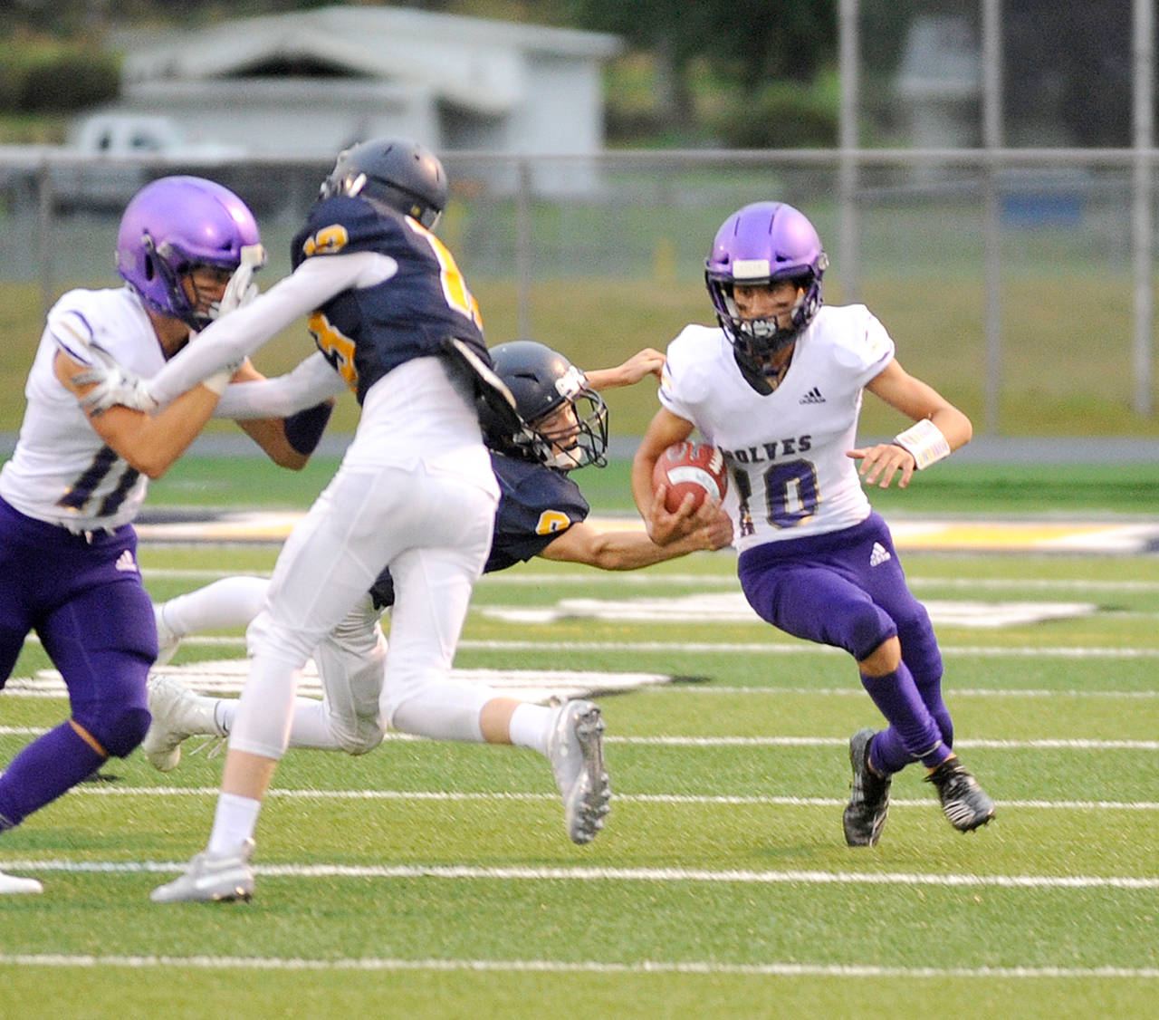 Michael Dashiell/Olympic Peninsula News Group Sequim’s Garrett Hoesel runs with the football during a win over Forks last week.