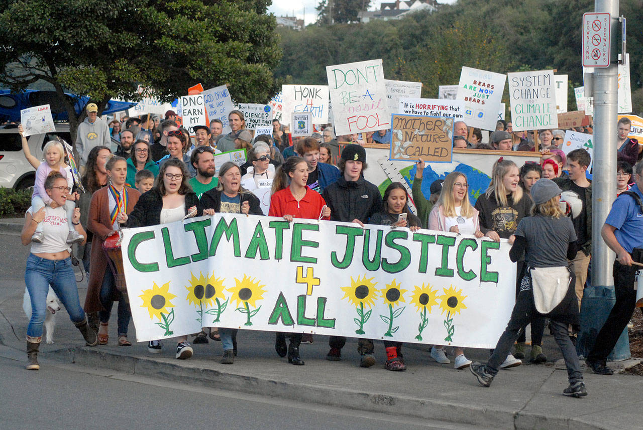 Climate Strike participants, many carrying signs, begin their march through the streets of Port Angeles after a rally near Hollywood Beach on Friday. About 300 people took part in the event. (Keith Thorpe/Peninsula Daily News)