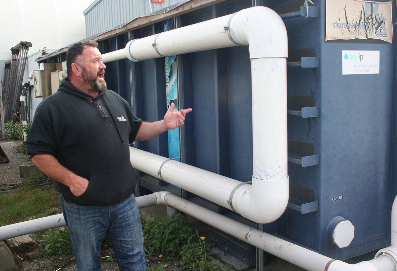 Terry Khile, the hoist and yard manager for the Port of Port Townsend, said stormwater collected in one of five separate areas at the boatyard travels through a filtration box that has several levels of mixed media, including sand and biochar, before it’s released into Puget Sound. (Brian McLean/Peninsula Daily News)